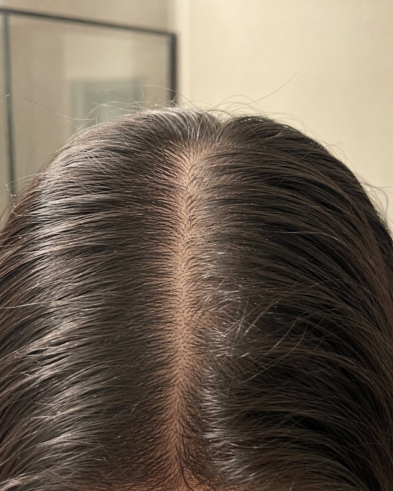 Oily flat roots under bathroom light