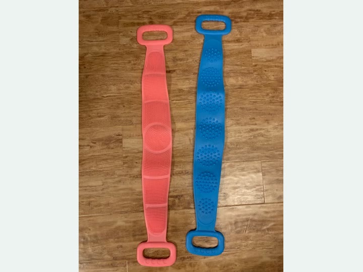 Customer photo showing one Pink and one Blue double-ended silicone back scrubber laid flat