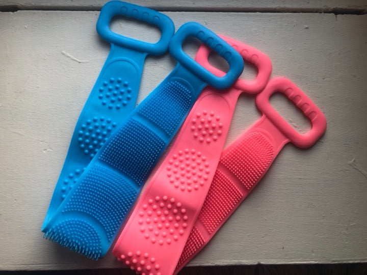 Customer photo showing Blue and Pink double-ended silicone back scrubbers with both textured faces visible