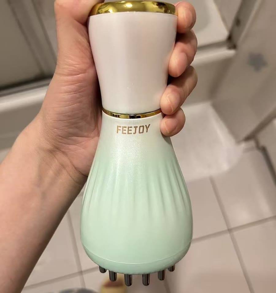 Customer photo holding the green handheld massager