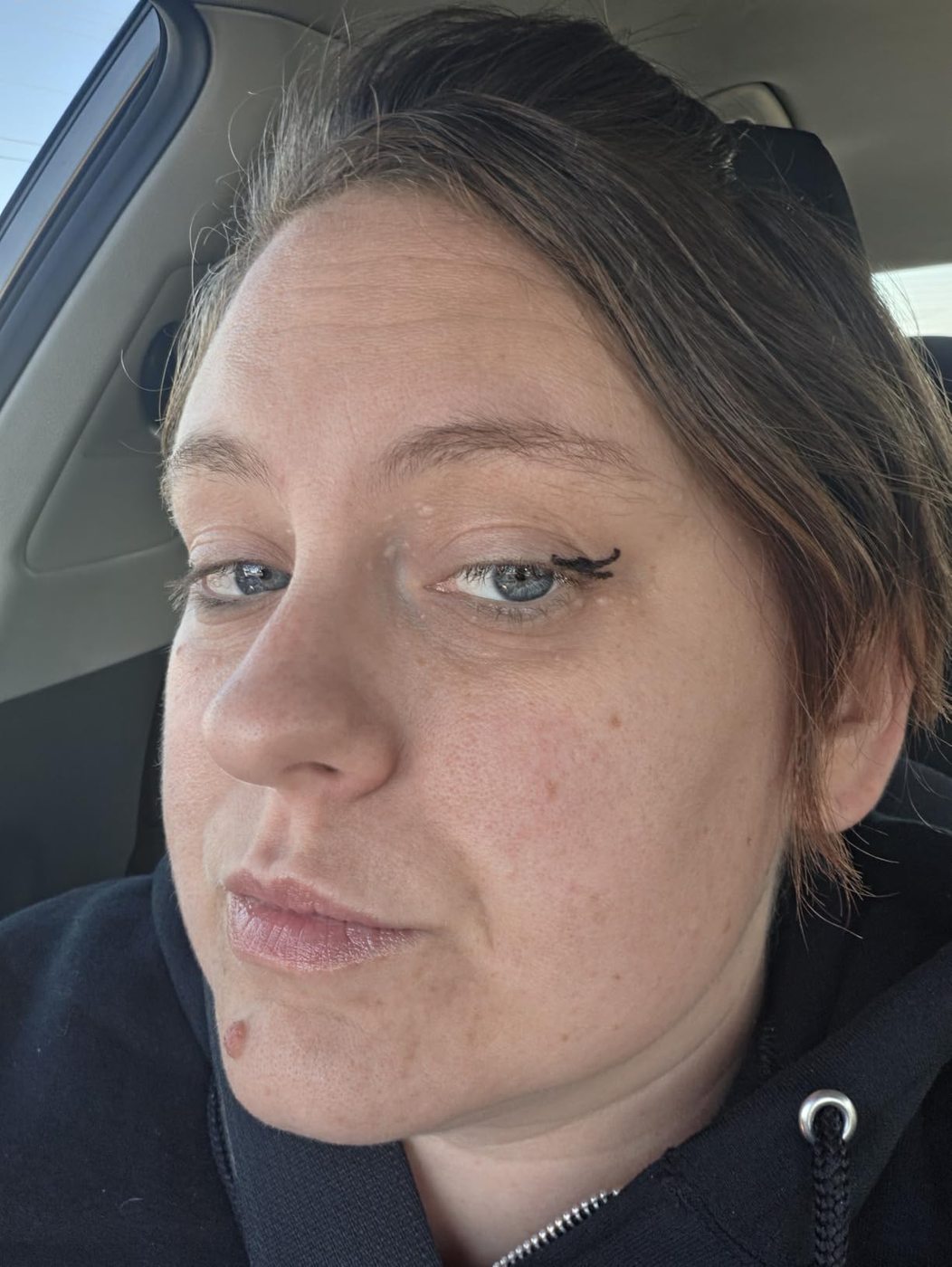 Natural-light customer selfie showing a winged eyeliner result.