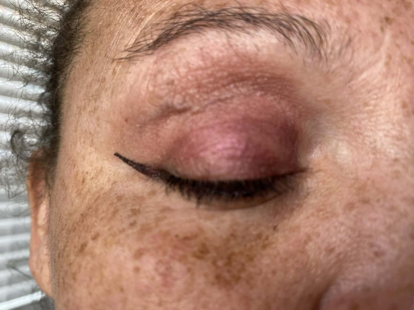 Close-up customer photo showing eyeliner on a hooded eyelid.