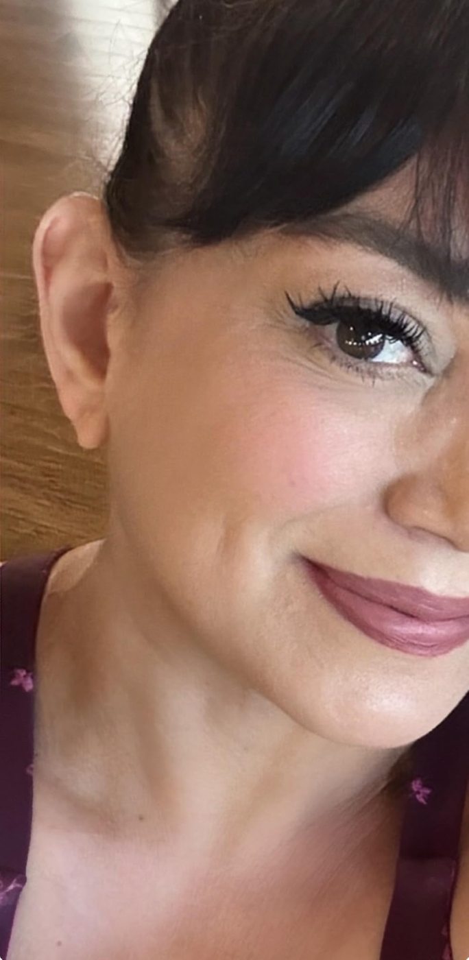Close-up customer selfie showing a bold black eyeliner wing.