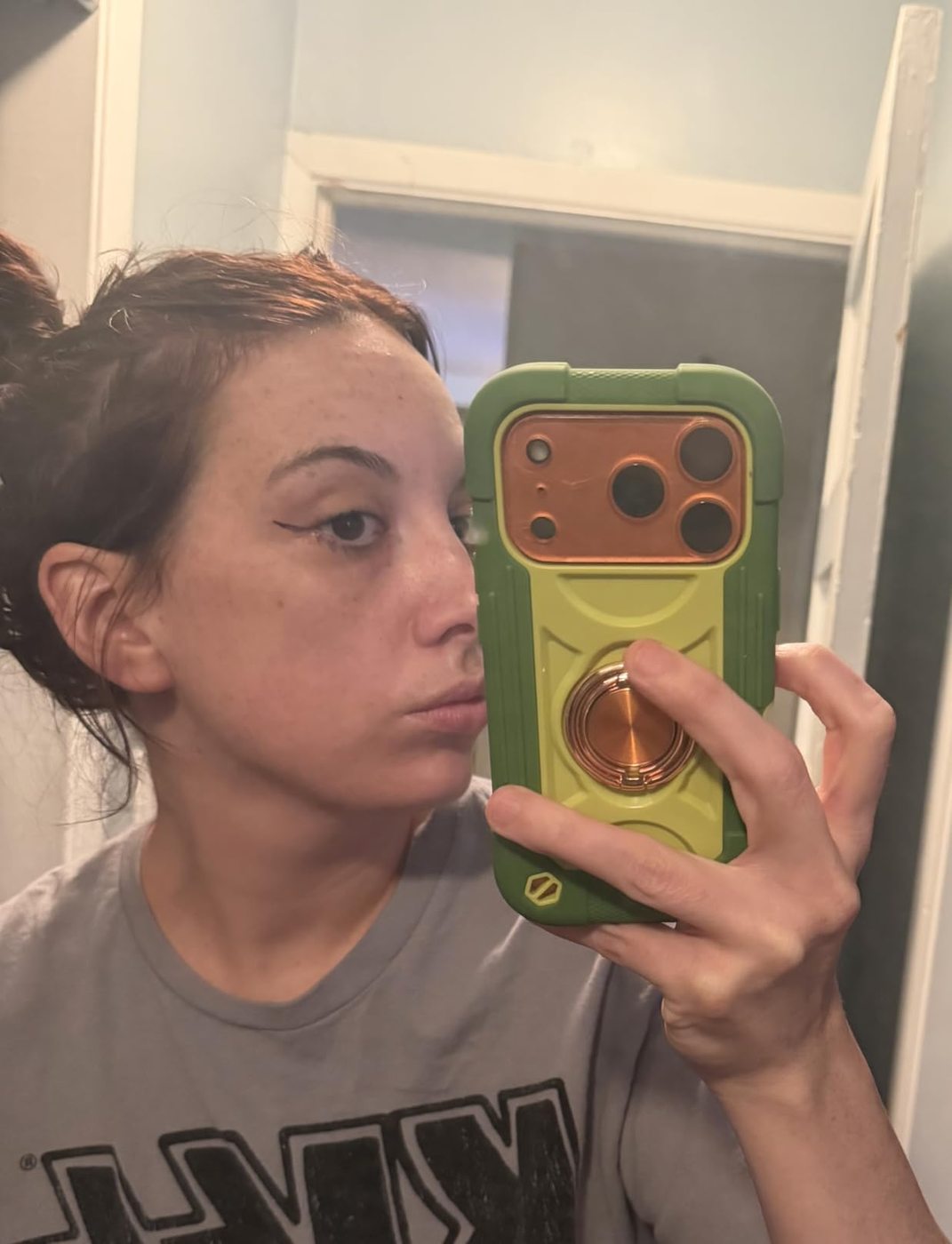 Mirror selfie showing a customer's eyeliner from the side.