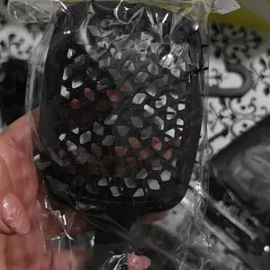 Customer-uploaded close-up of the matching black vented detangling brush