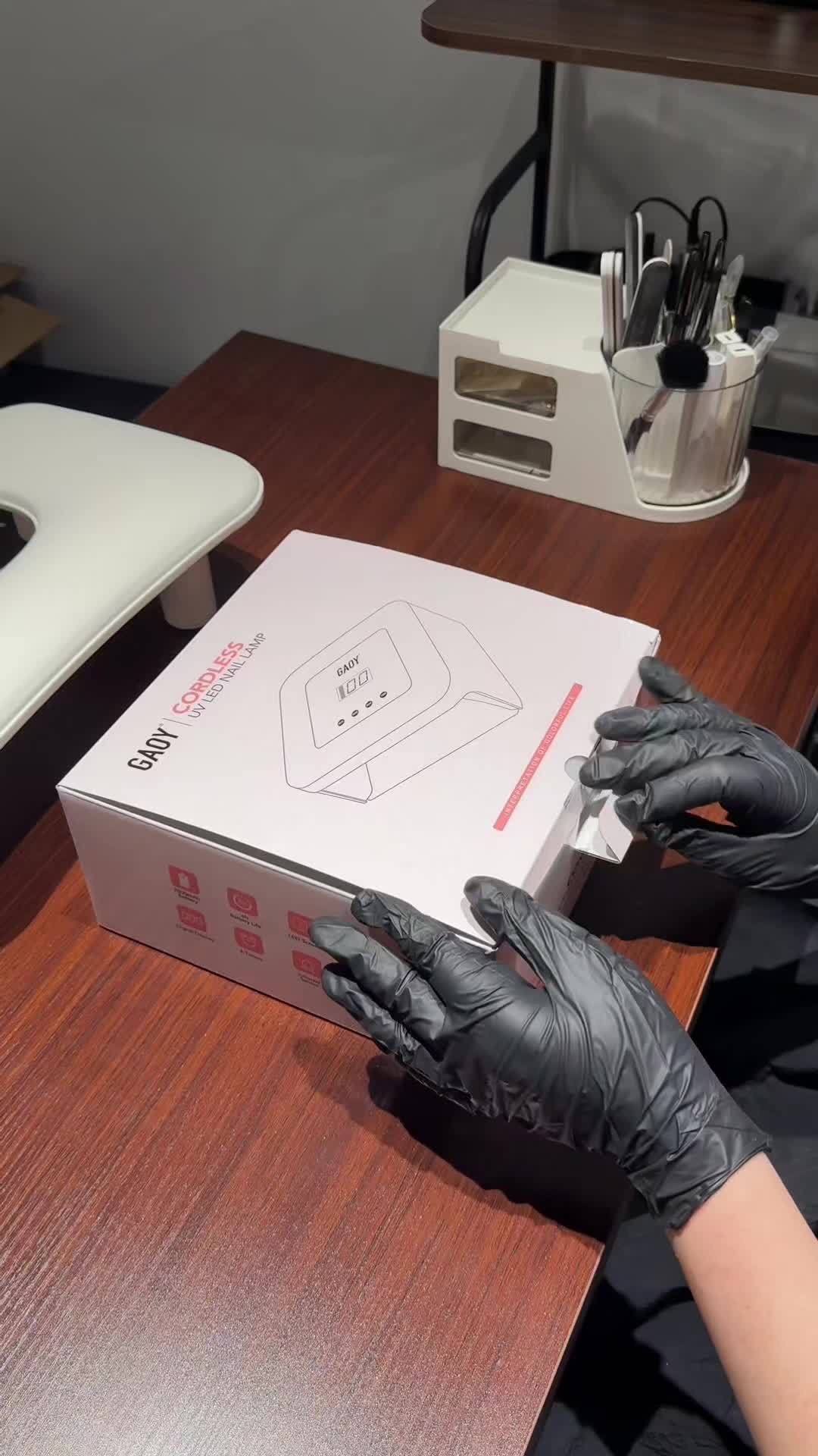 Manicurist unboxing the exact White GAOY cordless nail lamp